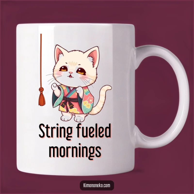 Start your day with a smile with this funny mug, featuring a mischievous kitten in a colorful kimono batting at a string. A delightful gift for cat lovers.