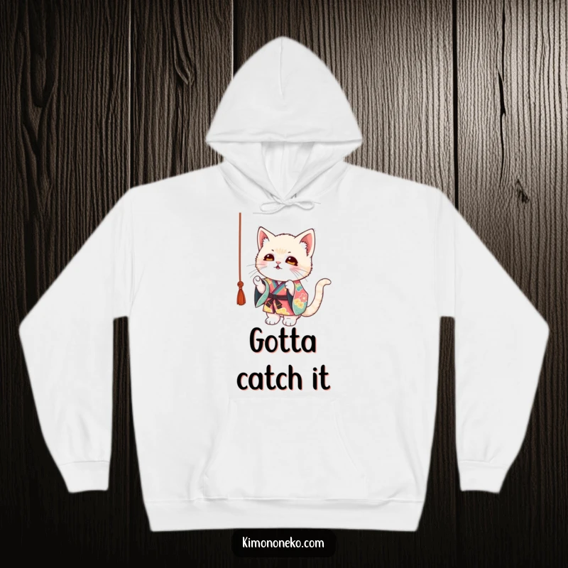 Funny Kitten Kimono Hoodie: A mischievous kitten in a colorful kimono playfully batting at a dangling string, cozy and fun.