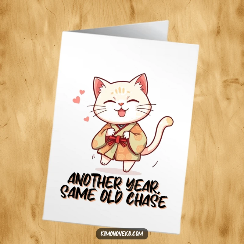 Funny Free Printable Birthday Card: Mischievous cat in traditional kimono chasing its own tail, comical and energetic.