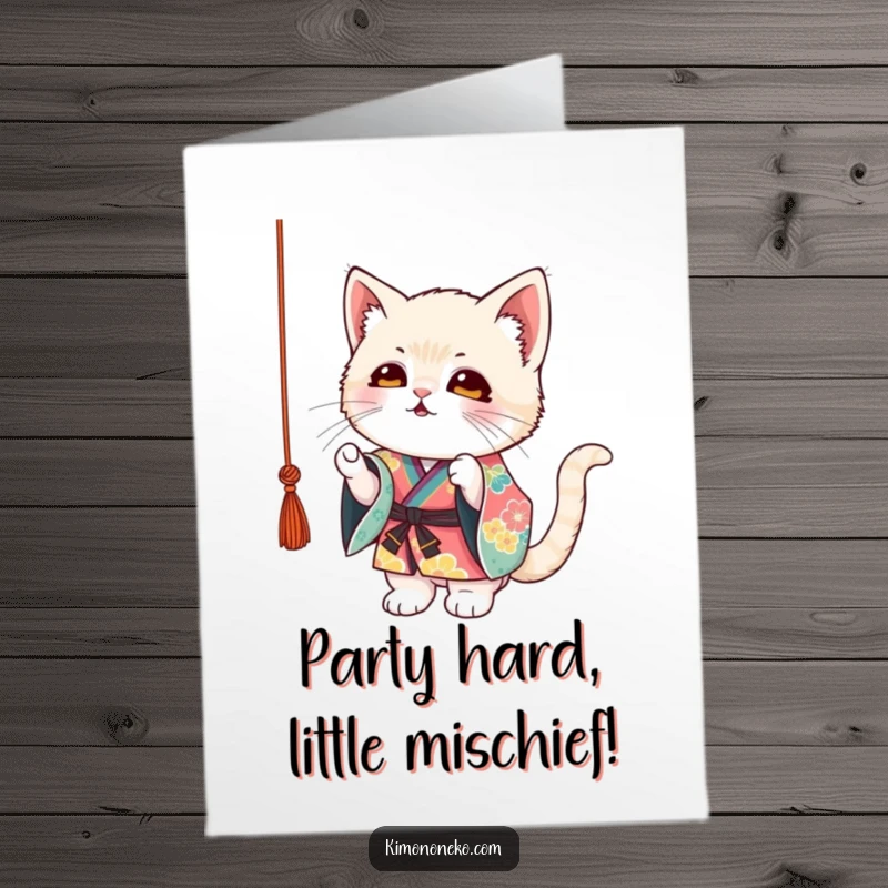 Funny Free Printable Birthday Card: Mischievous kitten in colorful kimono playfully batting at a dangling string with glee.