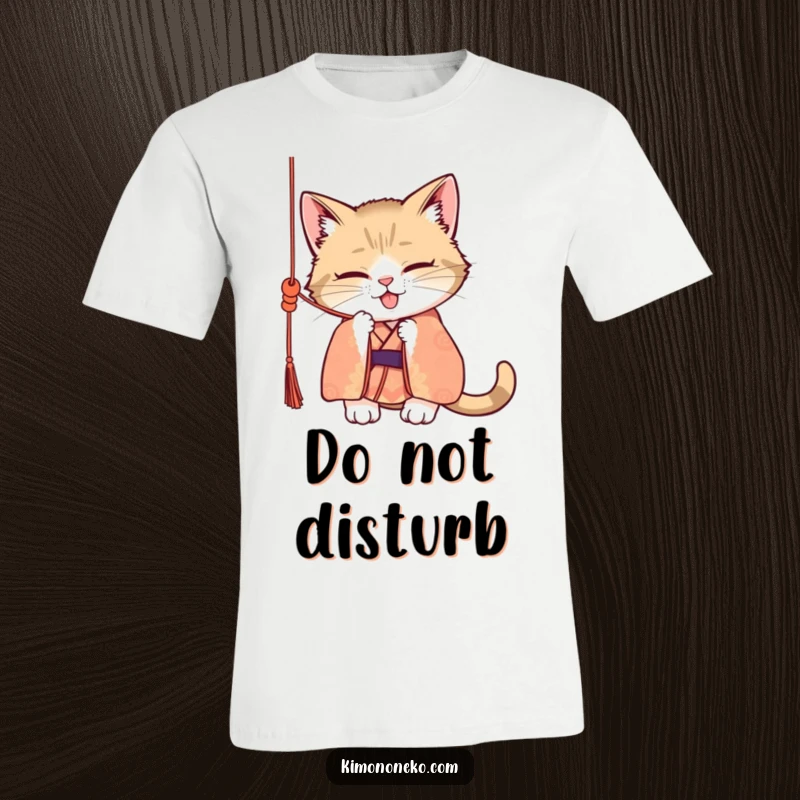 Funny t-shirt featuring a mischievous cat wearing a patterned kimono, enthusiastically batting at a dangling silk cord with playful intent.